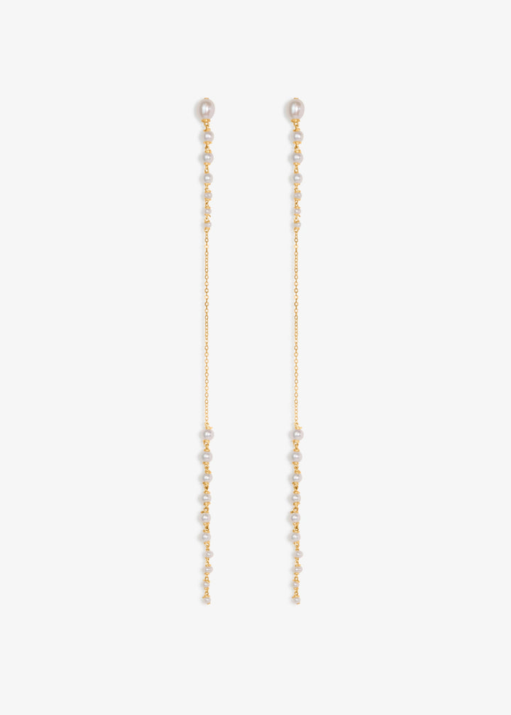 Posy - Minimal by design, but quietly captivating. These long earrings feature tapered strands of seed pearls, graduating from large to small, framing a single, reflective chain at the center. The effect is delicate yet striking, with just enough shimmer