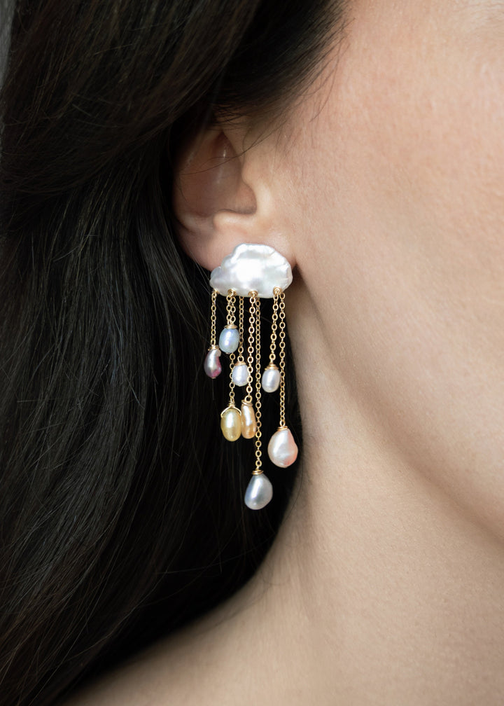 Rainstorm - These earrings feature two keshi pearls at the top, their textured shapes resembling thunderclouds, with colorful teardrop pearls cascading below like falling raindrops. Suspended from dainty chains at varying lengths, they create a striking d