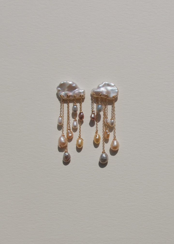 Rainstorm - These earrings feature two keshi pearls at the top, their textured shapes resembling thunderclouds, with colorful teardrop pearls cascading below like falling raindrops. Suspended from dainty chains at varying lengths, they create a striking d