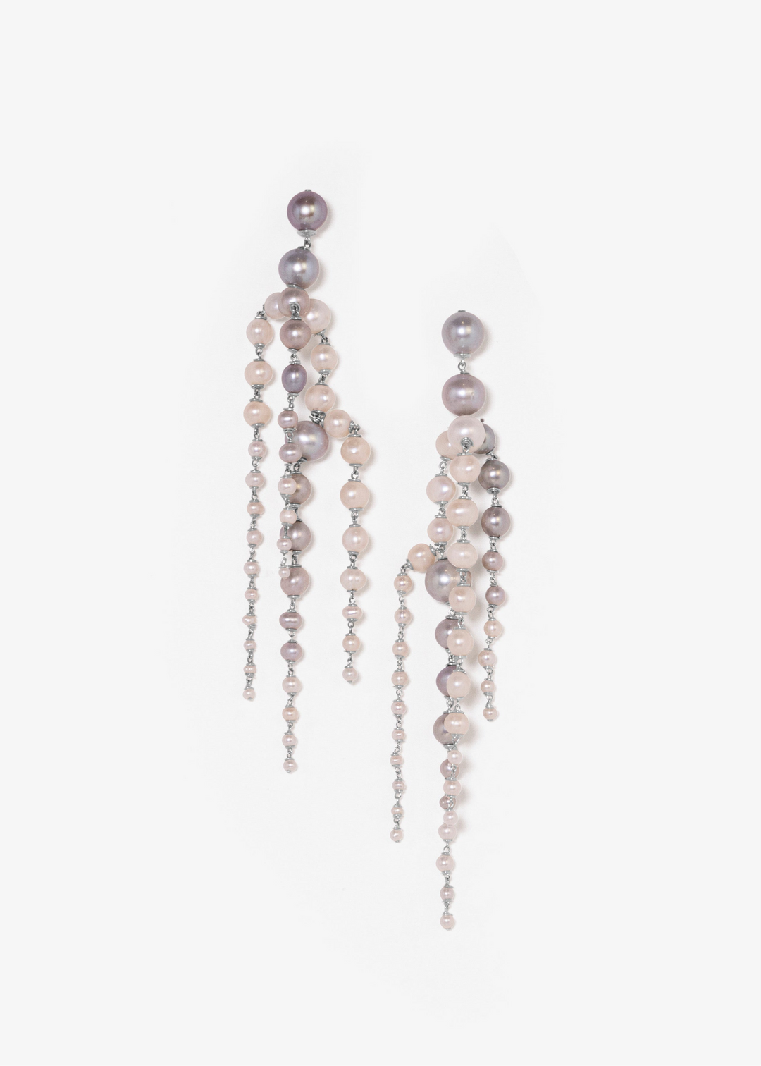 Rue - Crafted with silver pearls that gracefully taper into white seed pearls, these earrings are unlike any you’ve seen before. Striking yet soft, they sway with movement, adding an elegant touch to every look. The perfect statement piece to elevate any