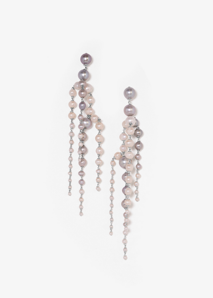 Rue - Crafted with silver pearls that gracefully taper into white seed pearls, these earrings are unlike any you’ve seen before. Striking yet soft, they sway with movement, adding an elegant touch to every look. The perfect statement piece to elevate any