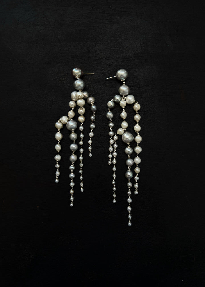 Rue - Crafted with silver pearls that gracefully taper into white seed pearls, these earrings are unlike any you’ve seen before. Striking yet soft, they sway with movement, adding an elegant touch to every look. The perfect statement piece to elevate any