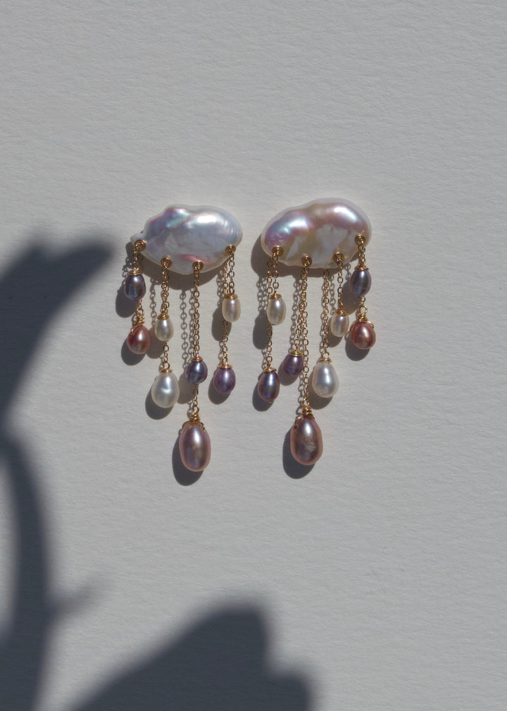 Tempest earrings on a light wall with plant shadow