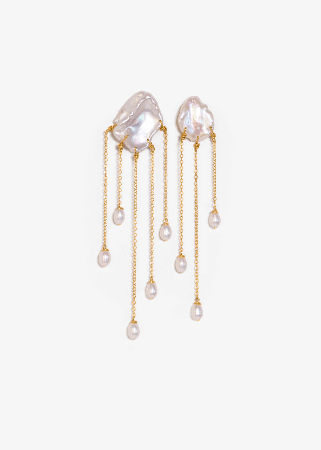 Sierra - Two one-of-a-kind keshi pearls serve as the focal point of these earrings, their organic shapes and colors radiating untamed beauty. Suspended from 14k gold chains, the asymmetrical design flows with effortless elegance, adding a touch of intrigu