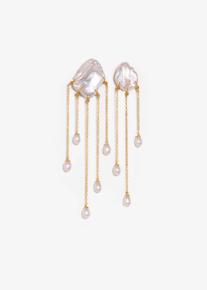 Sierra - Two one-of-a-kind keshi pearls serve as the focal point of these earrings, their organic shapes and colors radiating untamed beauty. Suspended from 14k gold chains, the asymmetrical design flows with effortless elegance, adding a touch of intrigu