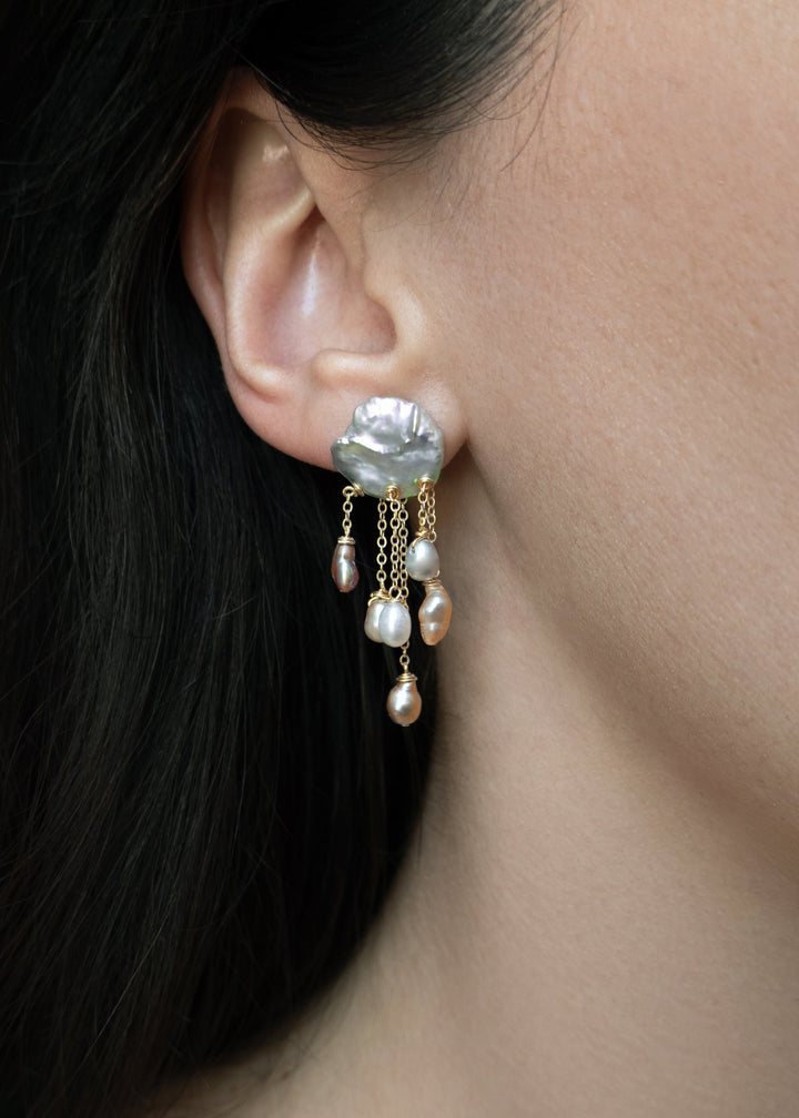 Squall - Like a sudden summer storm, the Squall earrings are full of color, movement, and quiet intensity. At the top sit two blue keshi pearls, moody and iridescent, while twelve pearls in varying tones cascade below. Vivid, sculptural, and softly dramat