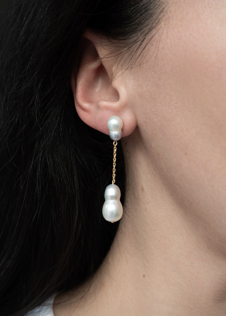 Stella - Suspended from a delicate rope chain, these white and silver baroque pearls bring a touch of soft sophistication. Their irregular forms catch the light beautifully, celebrating individuality in every detail. 14K Solid Gold Freshwater Baroque pear