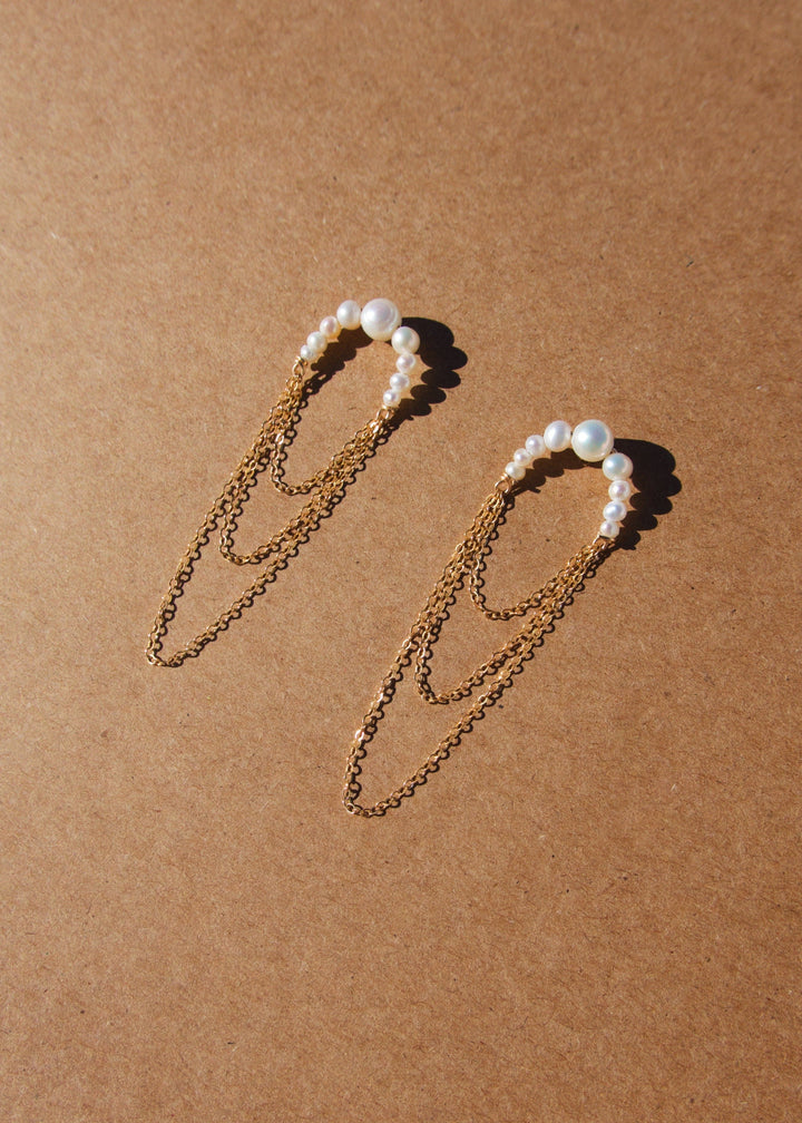 Earrings with three layered gold-filled chains and attached descending pearls