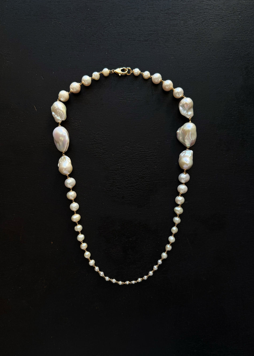 Wren Necklace - A classic baroque pearl necklace — but with a bit more drama. Bold, oversized pearls at the back taper into delicate seed pearls at the front, creating an unexpected silhouette that captivates and intrigues. 14K Gold-Filled Tarnish-Resista