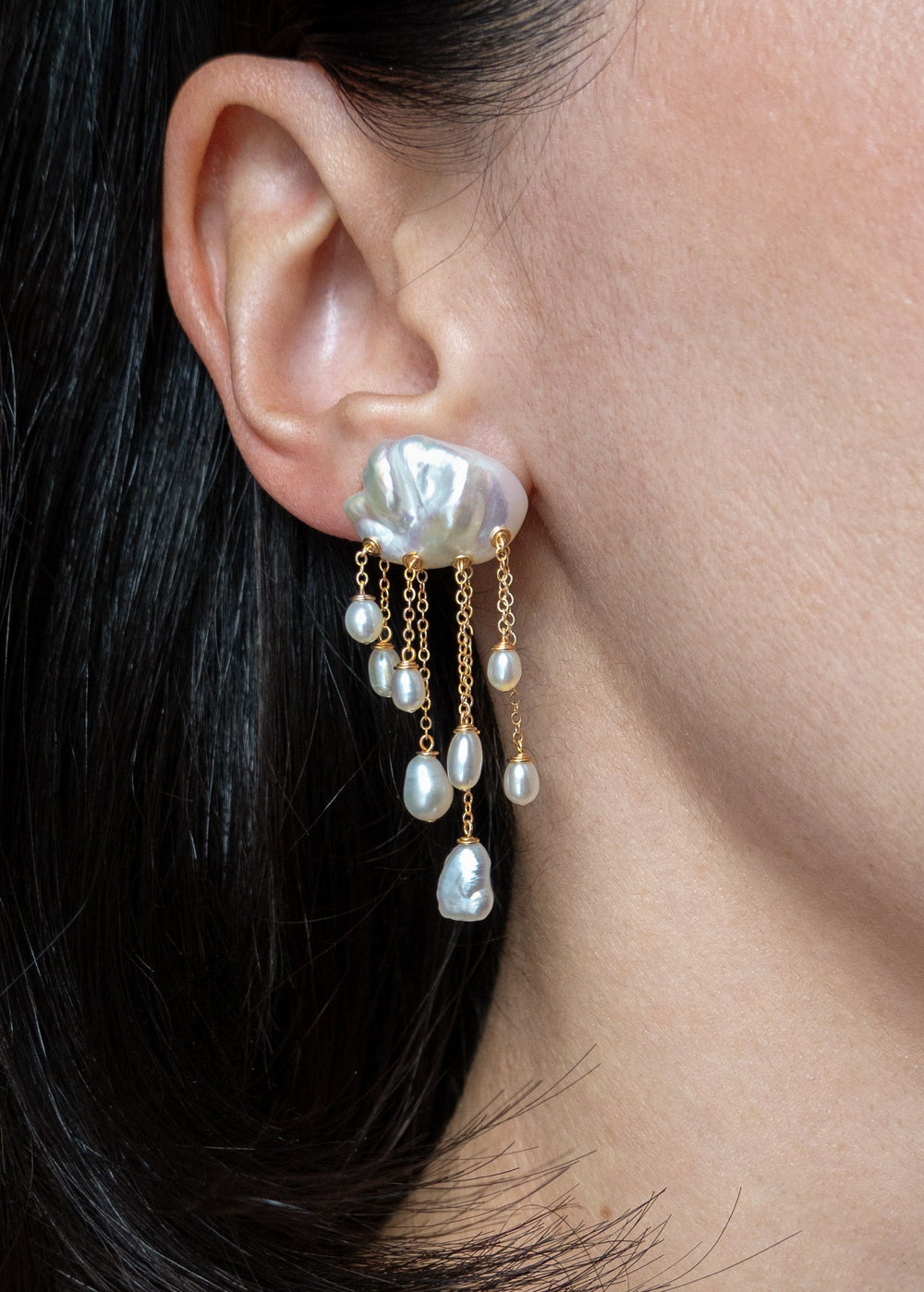 Snowfall earrings worn on a model's ear