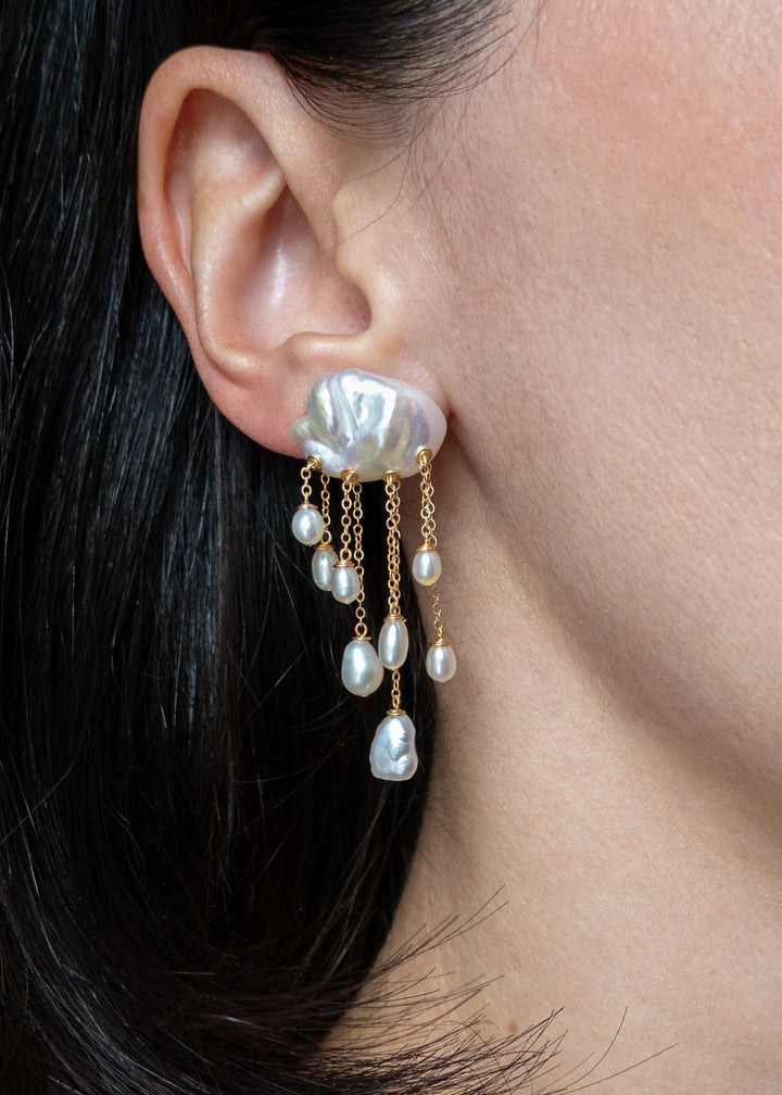 Snowfall earrings worn on a model&